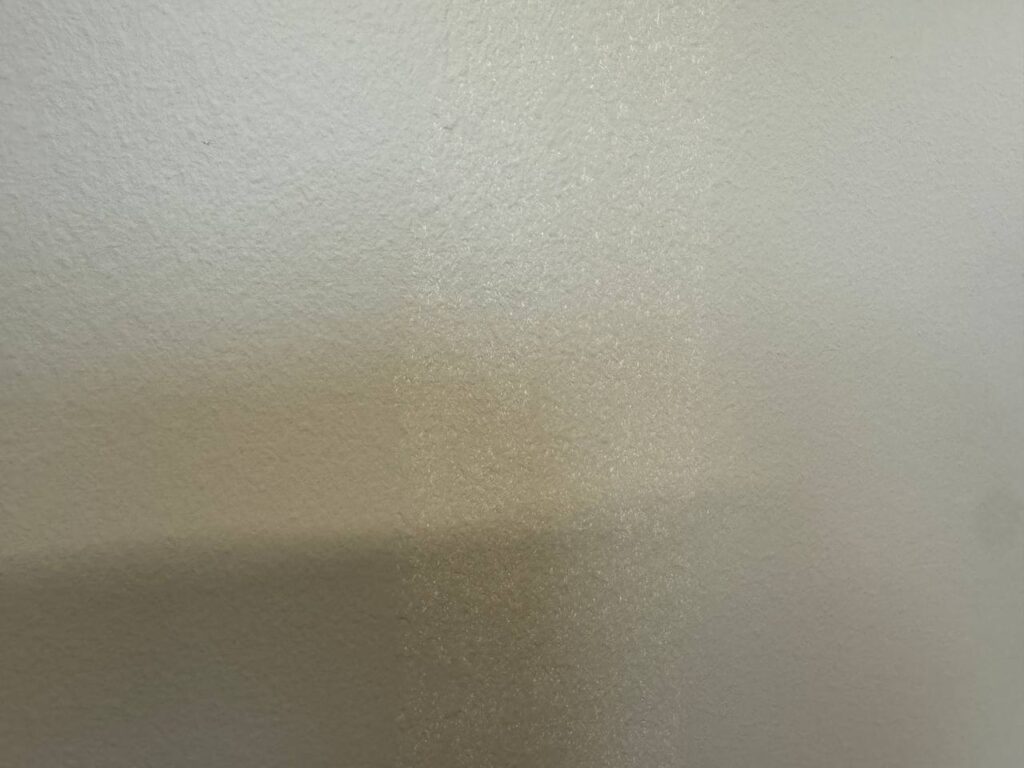 Uneven paint texture on a wall, possibly due to poor contractor work.