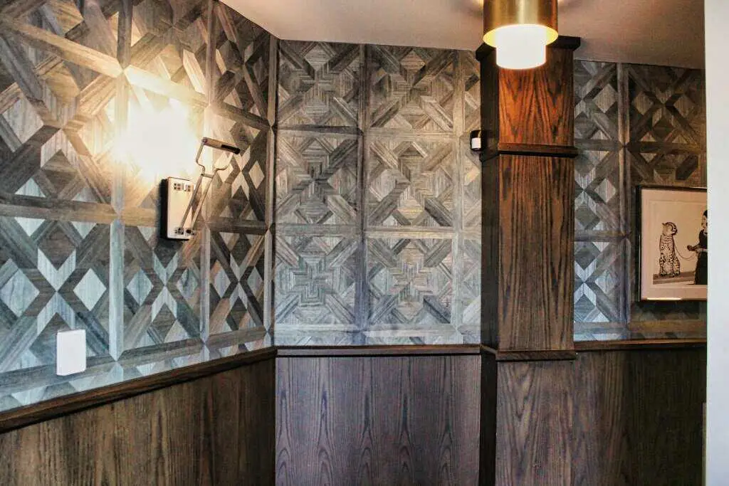 Textured geometric commercial vinyl wallcovering in a modern entryway.