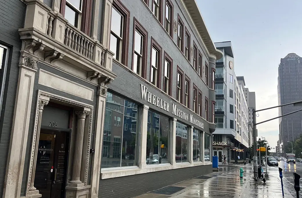 Wheeler Mission Ministries building exterior on a wet city street