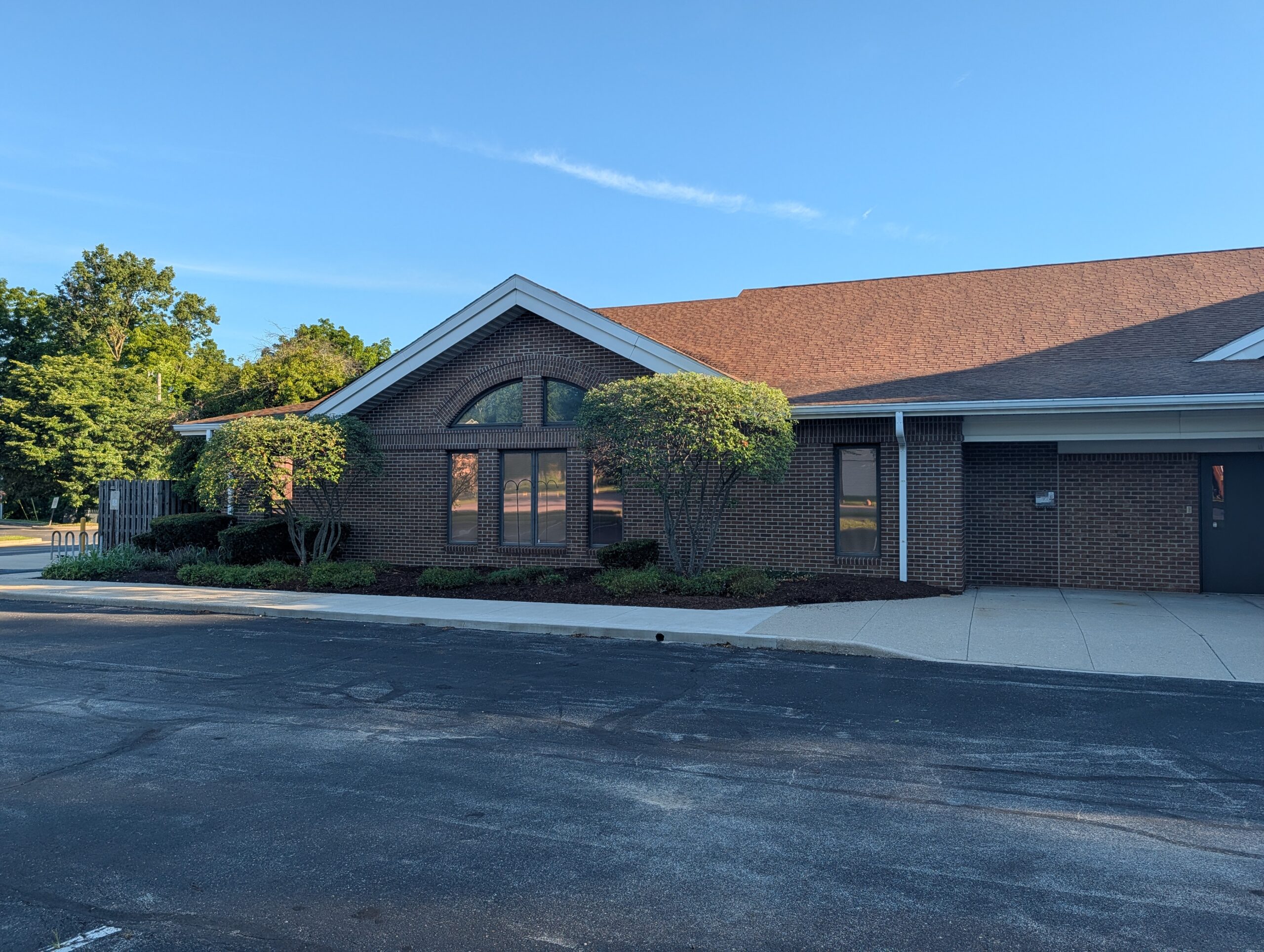 Brick Building With Arched Window And Trees Mooresville Public Library - Exterior Cleaning