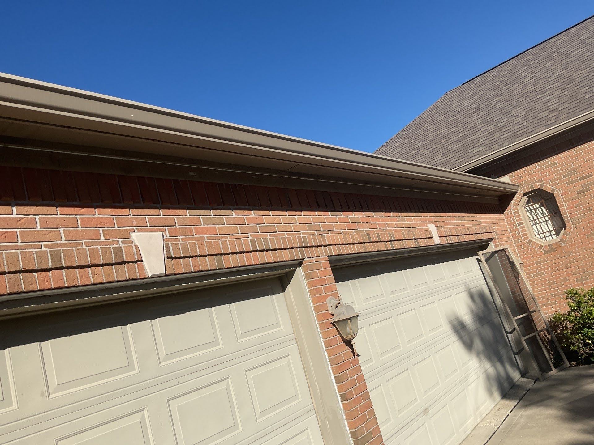 Brick Garage Doors With Gutter Lawton Residence exterior: painted brick, garage doors, and roof