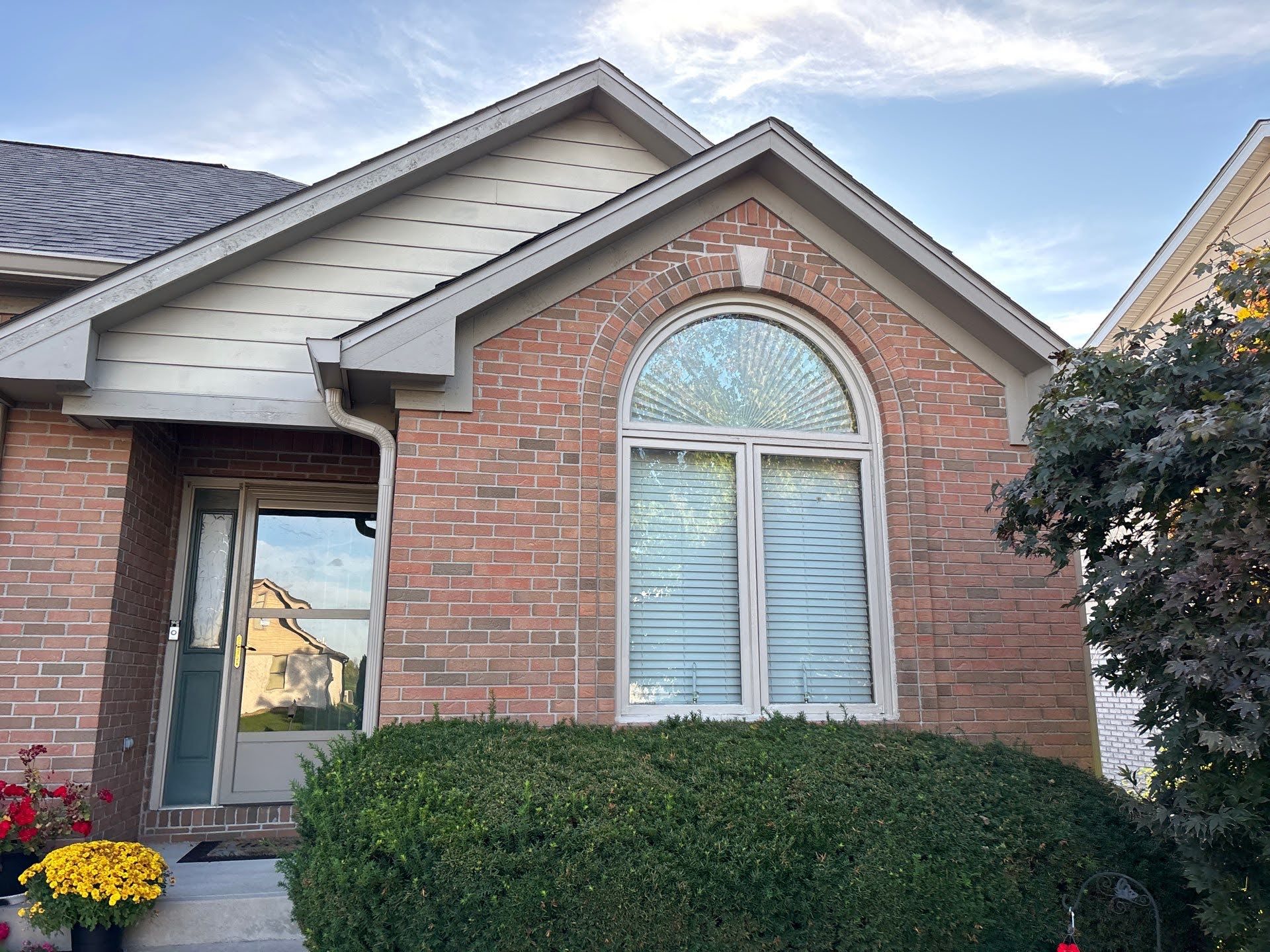 Brick House Arched Window Landscaping Brick house exterior with arched window, showing Lawton Residence painting potential.