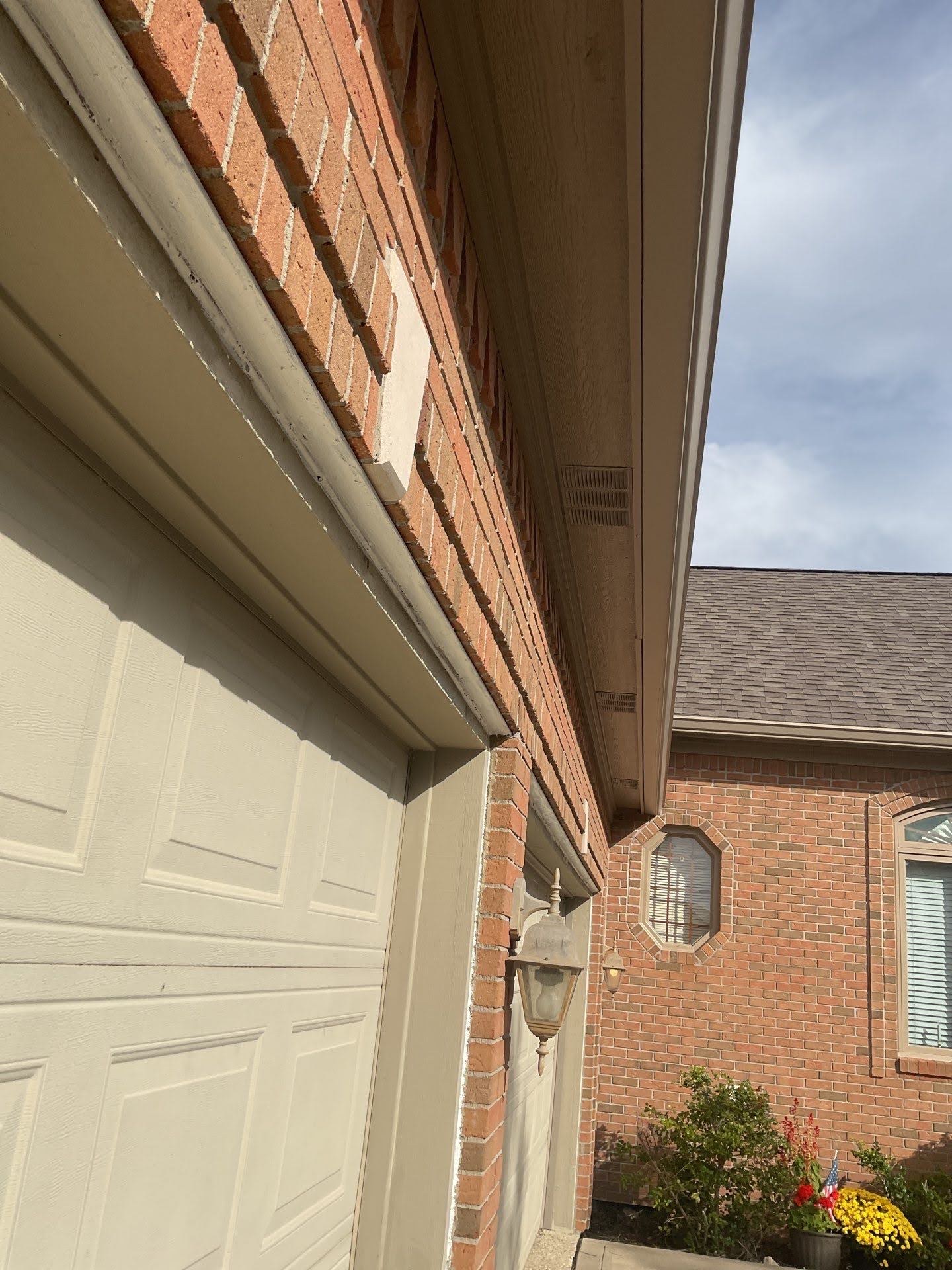Brick House Garage Eave Detail Lawton Residence exterior painting: Detail of brickwork and garage door trim.