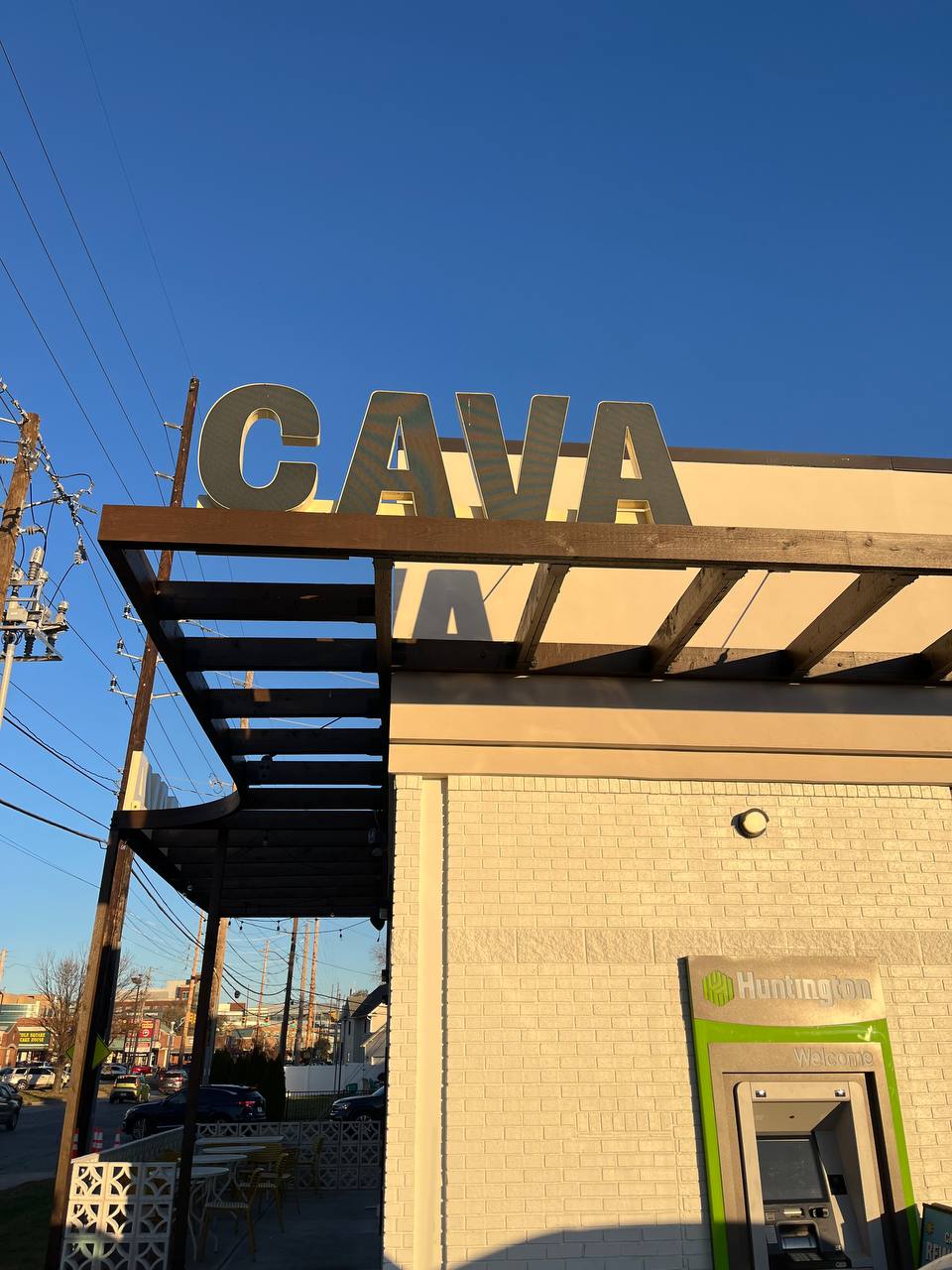 Cava Huntington Bank Exterior Signage Cava restaurant exterior with a wooden canopy and Huntington Bank ATM