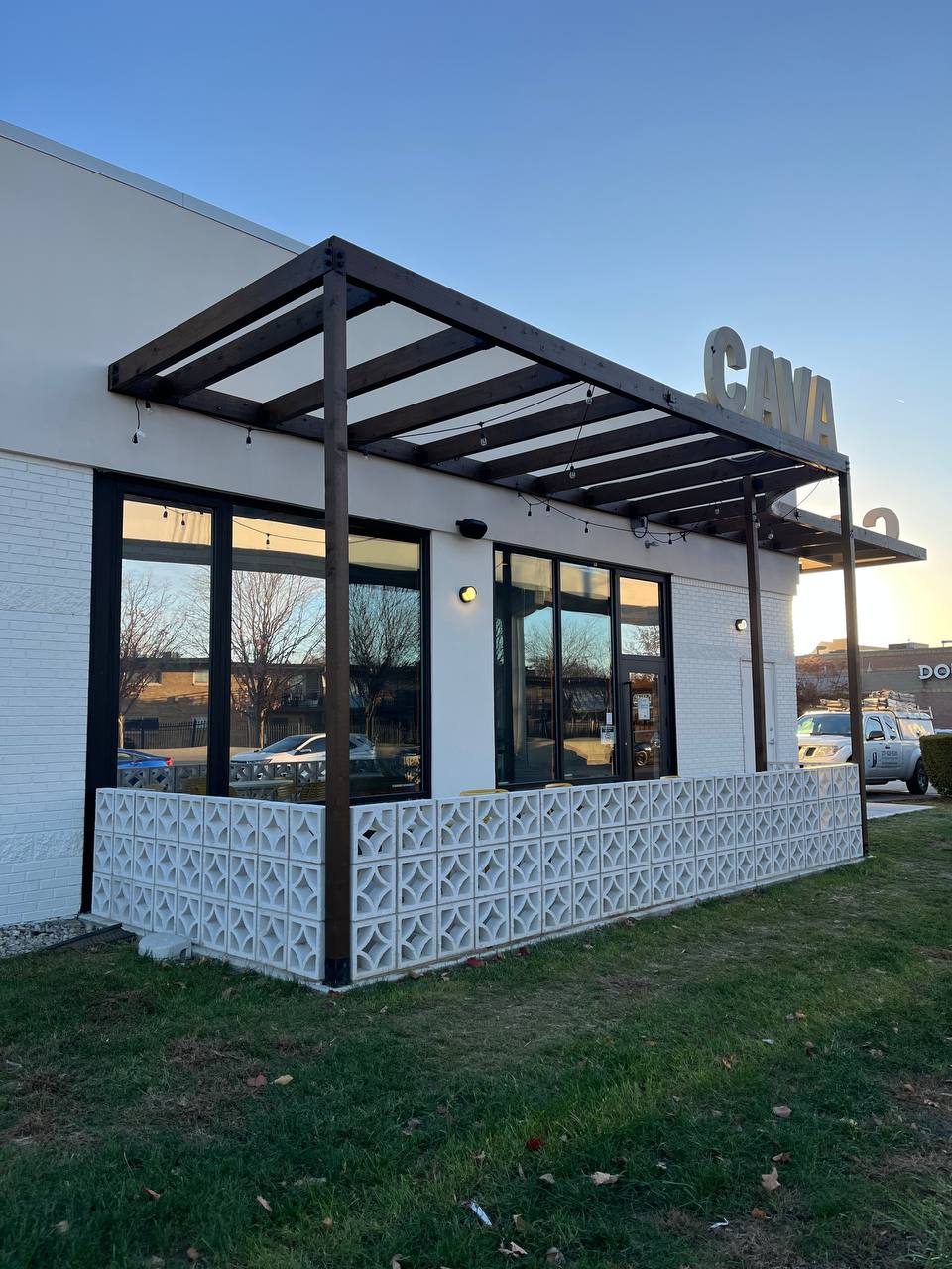 Cava Restaurant Exterior Modern Design Cava restaurant exterior with stained wooden canopy and white brick