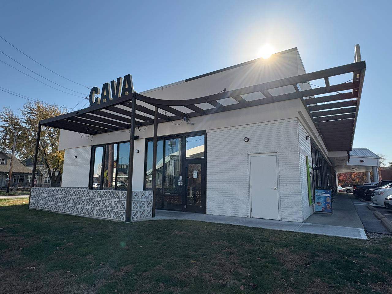 Cava Restaurant Exterior Sunlight Cava restaurant exterior with a modern canopy structure and sun glare.