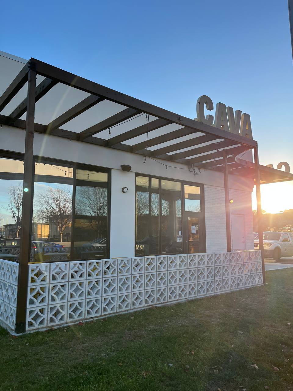 Cava Restaurant Exterior Sunset Patio Cava restaurant exterior with stained wood canopy and decorative screen