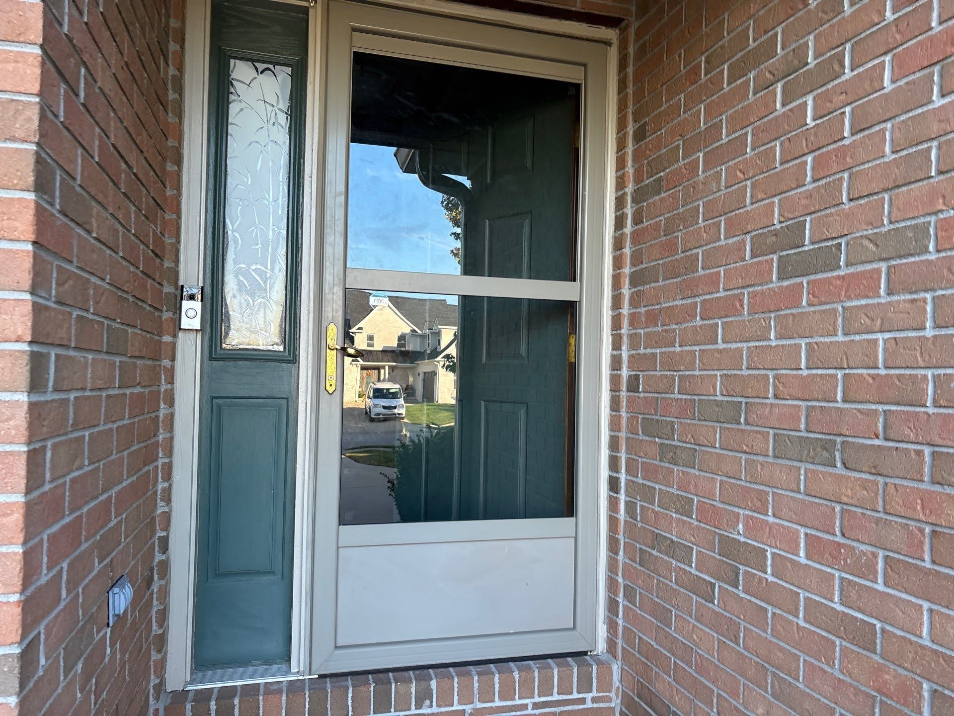 Front Entry Door With Screen And Brick Wall Lawton Residence exterior: green front door and brick wall
