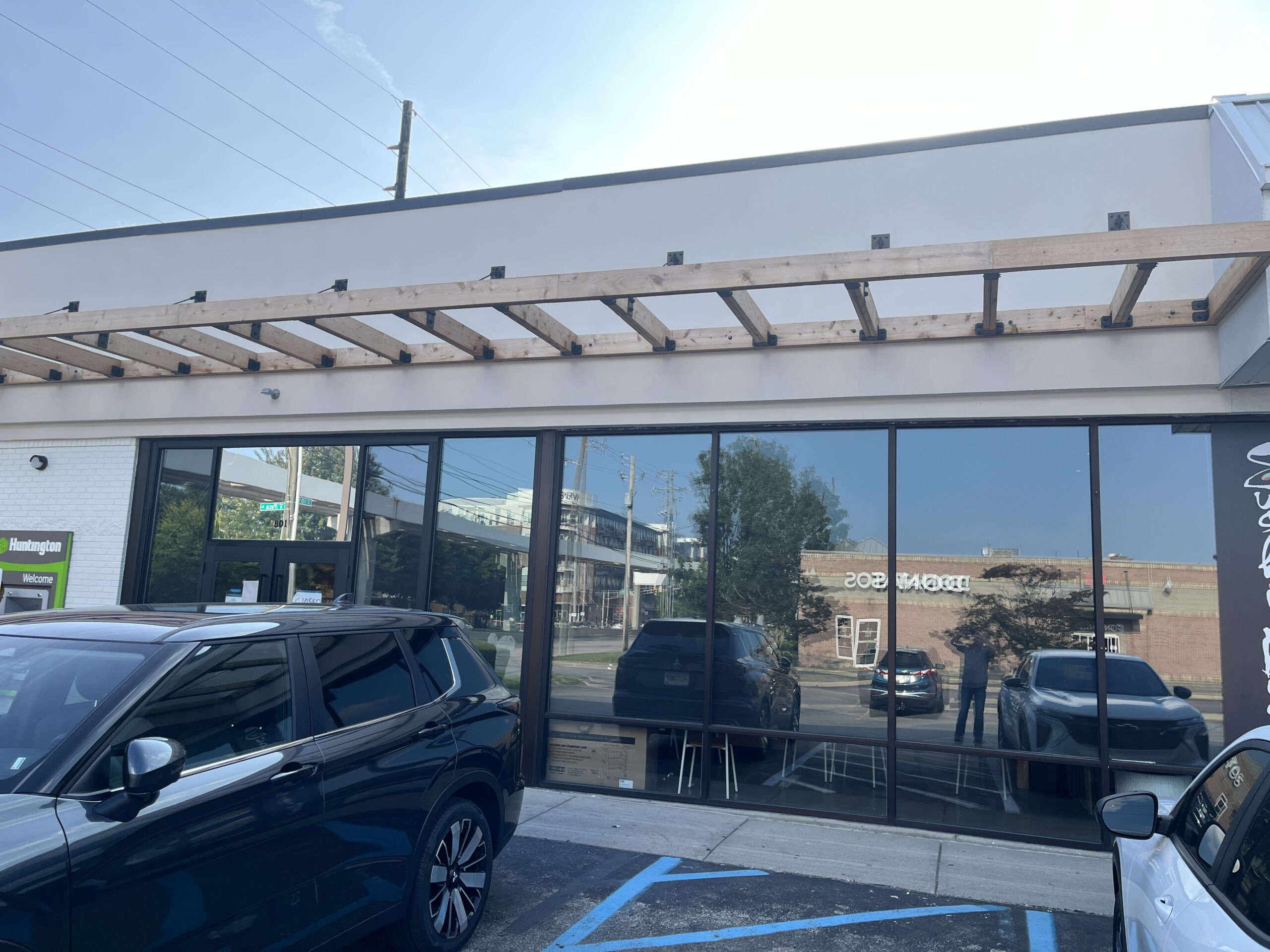 Huntington Bank Exterior Glass Windows Parking Lot Exterior of Cava restaurant with a new wooden canopy, Huntington Bank sign