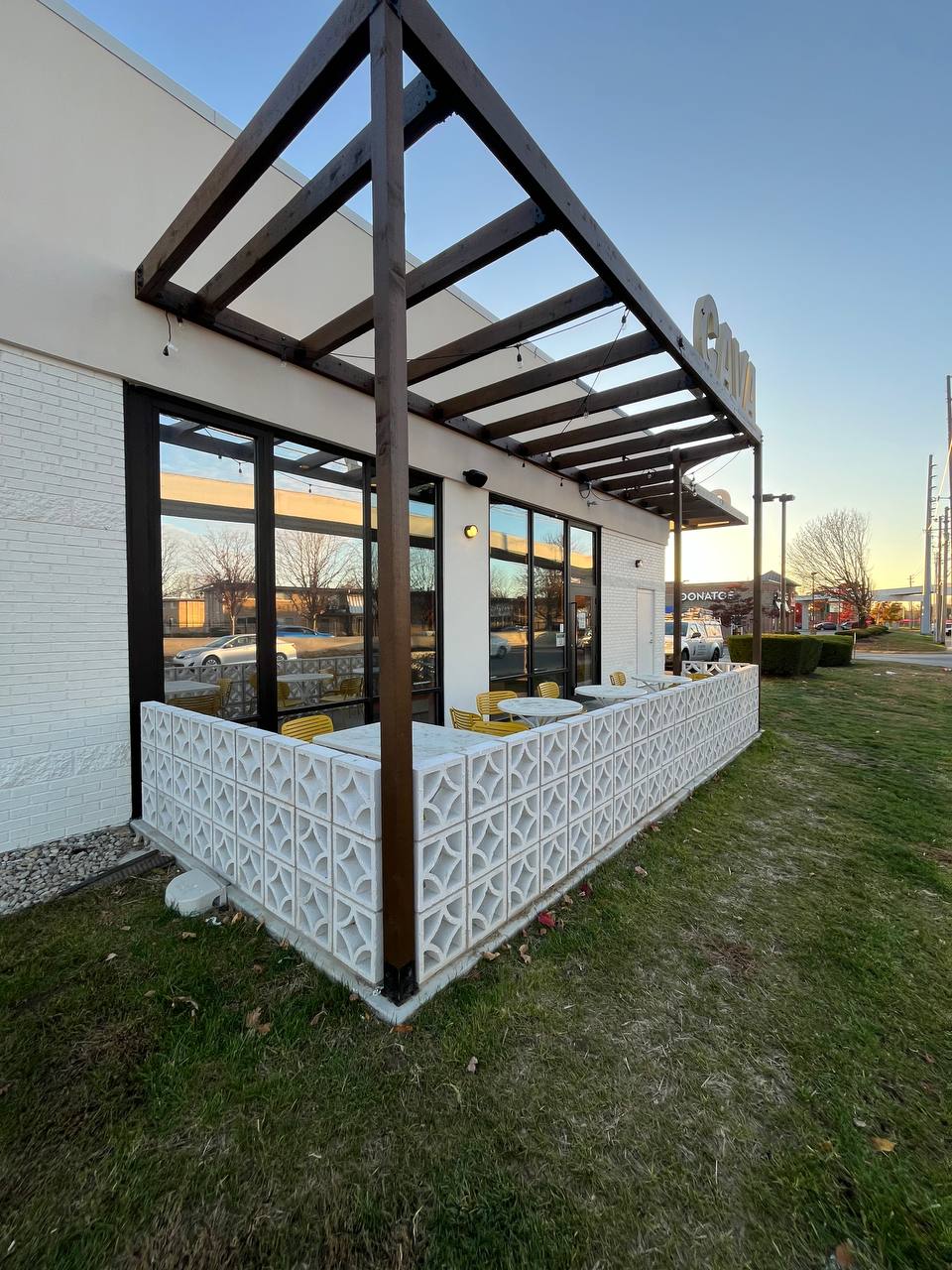 Outdoor Dining Area Cafe With Patterned Wall Cava canopy exterior with stained wood beams and decorative concrete wall.