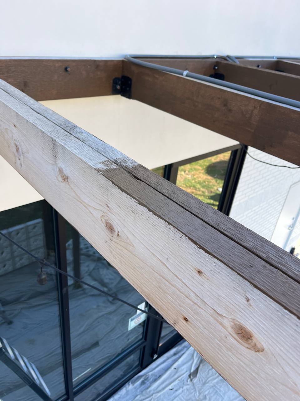 Wood Pergola Beam Stain Application Cava Canopy exterior staining: close-up of unfinished wood beam