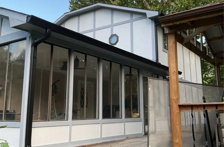 Exterior view of a house with a sunroom addition, painted by Zionsville IN residential painters.