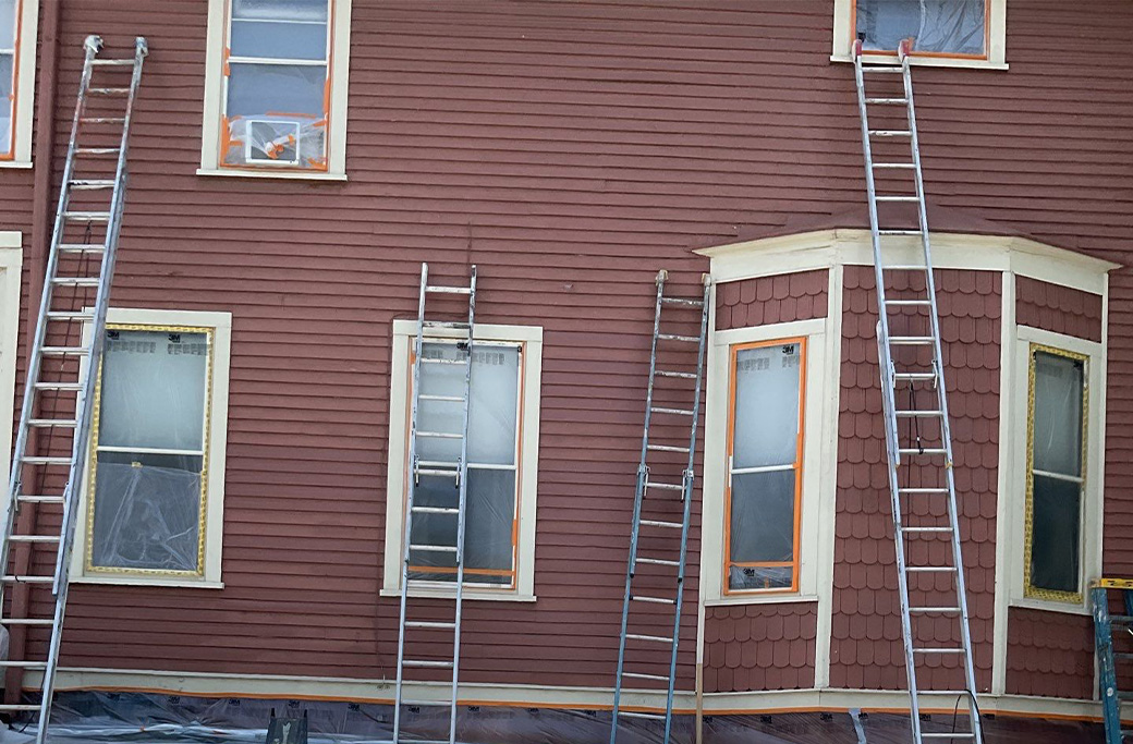 Before exterior house painting project showing home transformation in Indiana