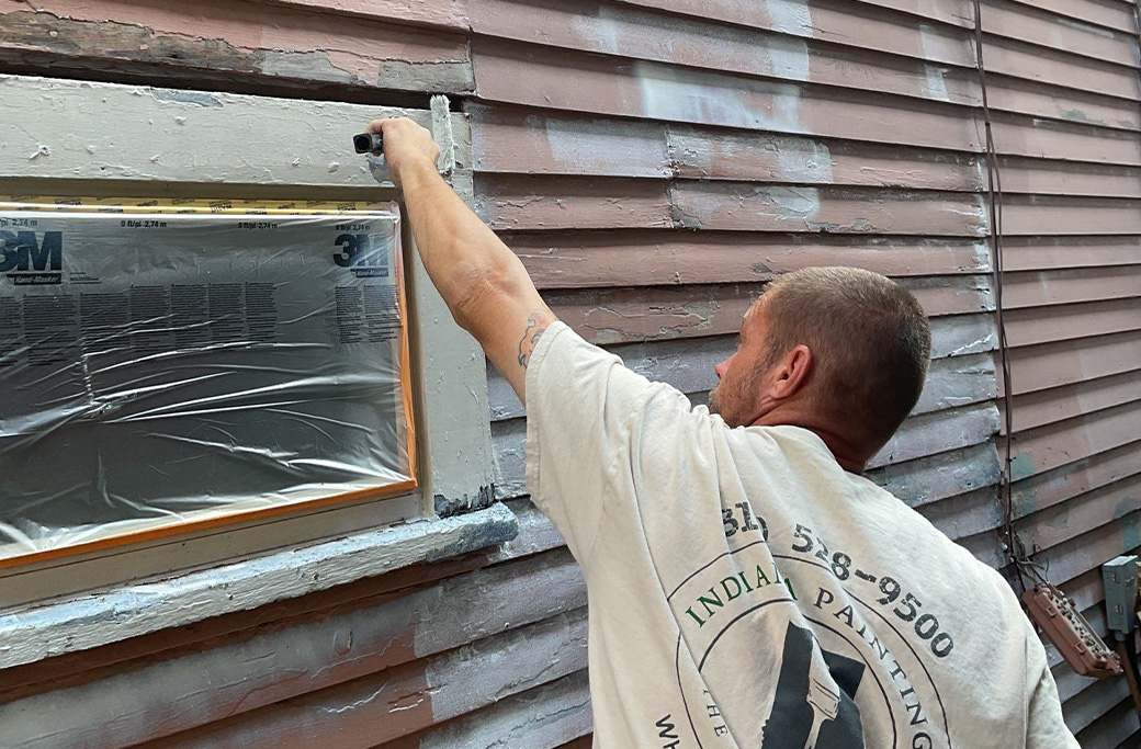 Indiana Painting Company painter working on an exterior painting project
