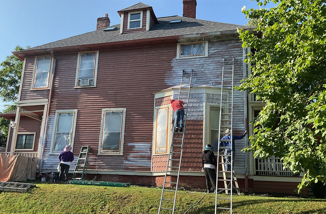 Professional exterior house painters completing a residential painting project in Indiana