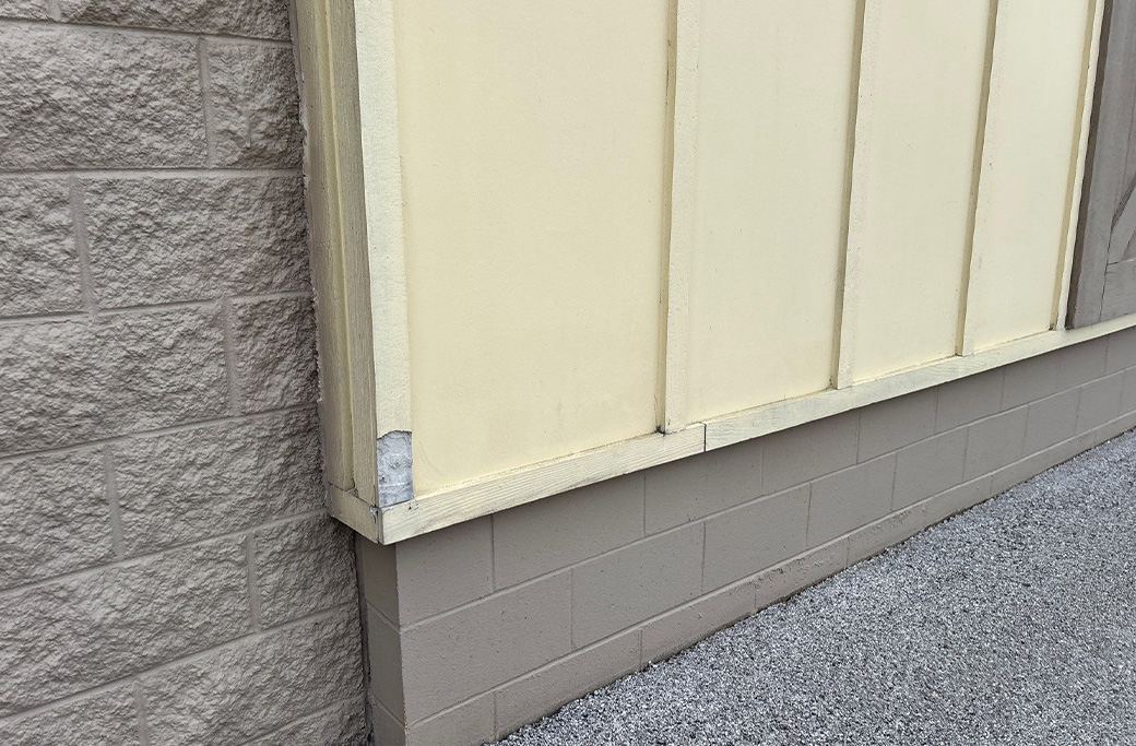 Common signs a commercial building needs repainting including peeling paint and surface damage