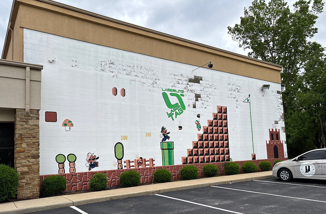 Peeling exterior paint on a LaserLite building in Bloomington showing signs of wear before commercial repainting