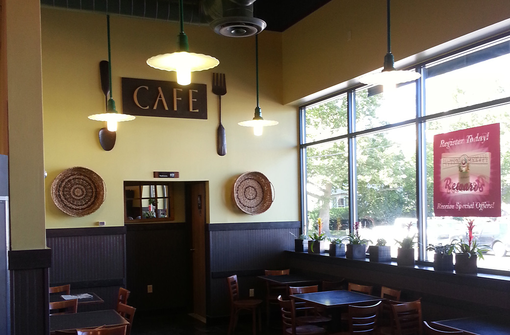 Yellow cafe interior with large windows and "CAFE" sign