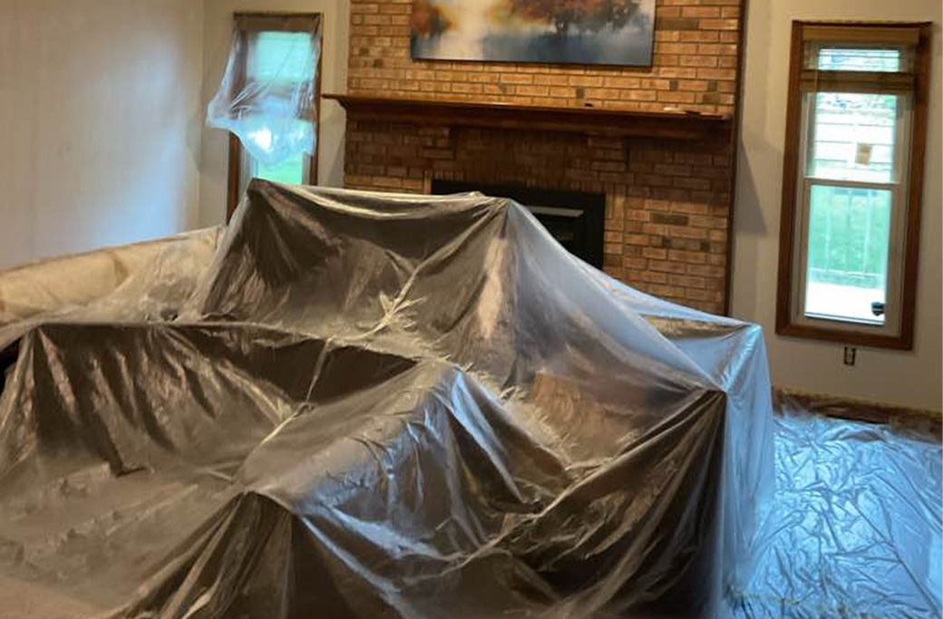 Furniture moved and covered before interior painting by Indiana Painting Company