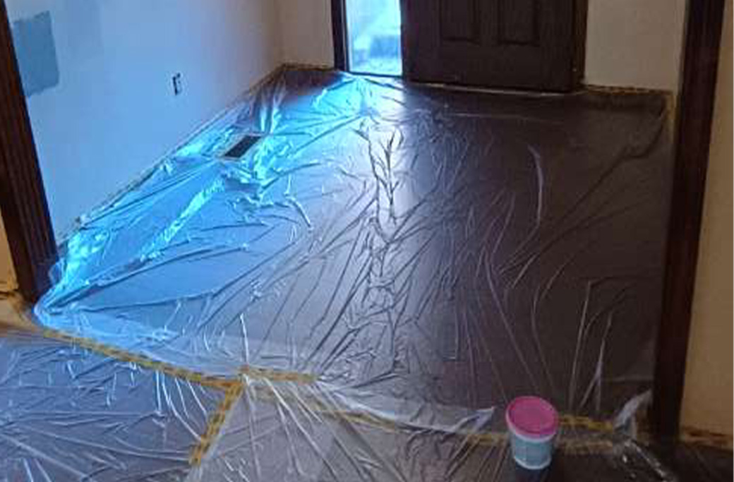 preferably with floor protection visibleClear walkway and protected floors prepared for an interior painting crew