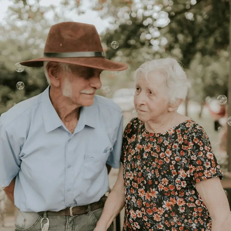 Happy retired couple smiling together outdoors